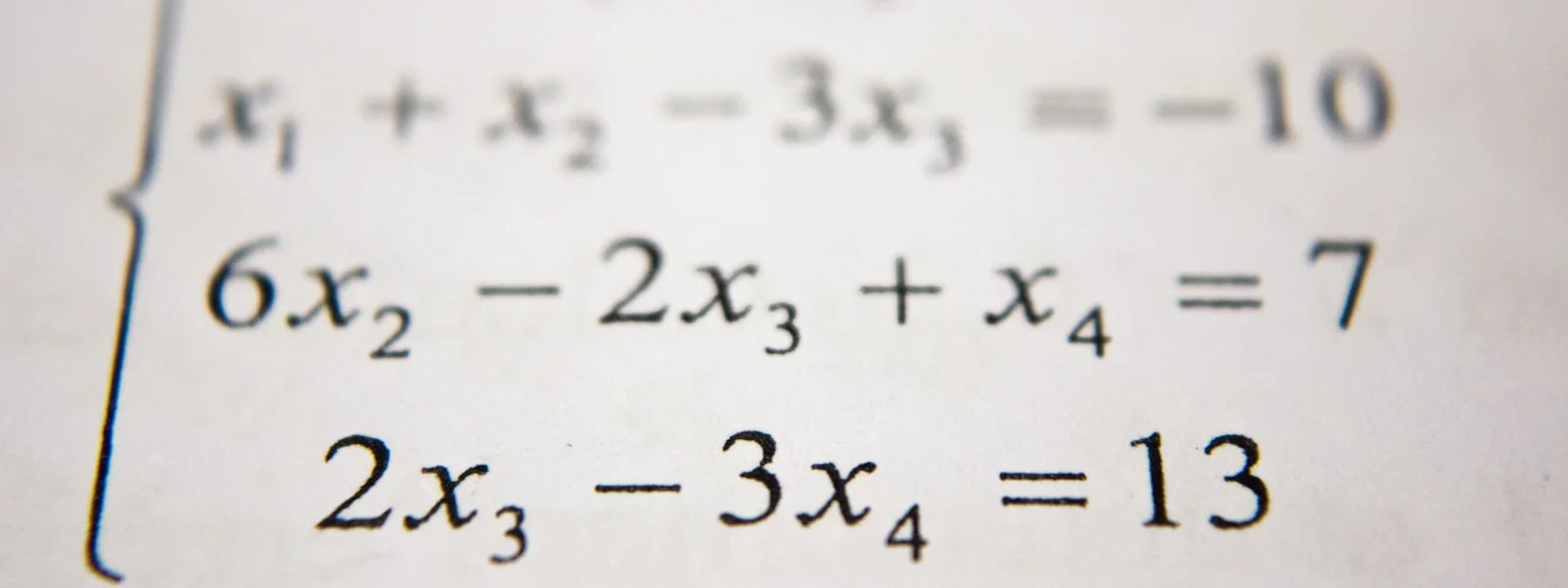 A system of linear equations printed in black ink on white paper